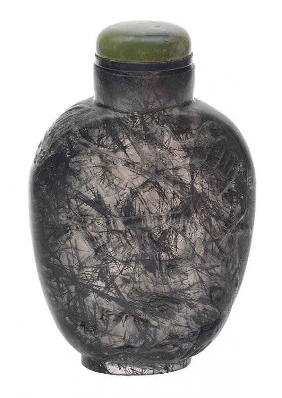 Appraisal: A CARVED HAIR CRYSTAL SNUFF BOTTLE WITH ONYX STOPPER