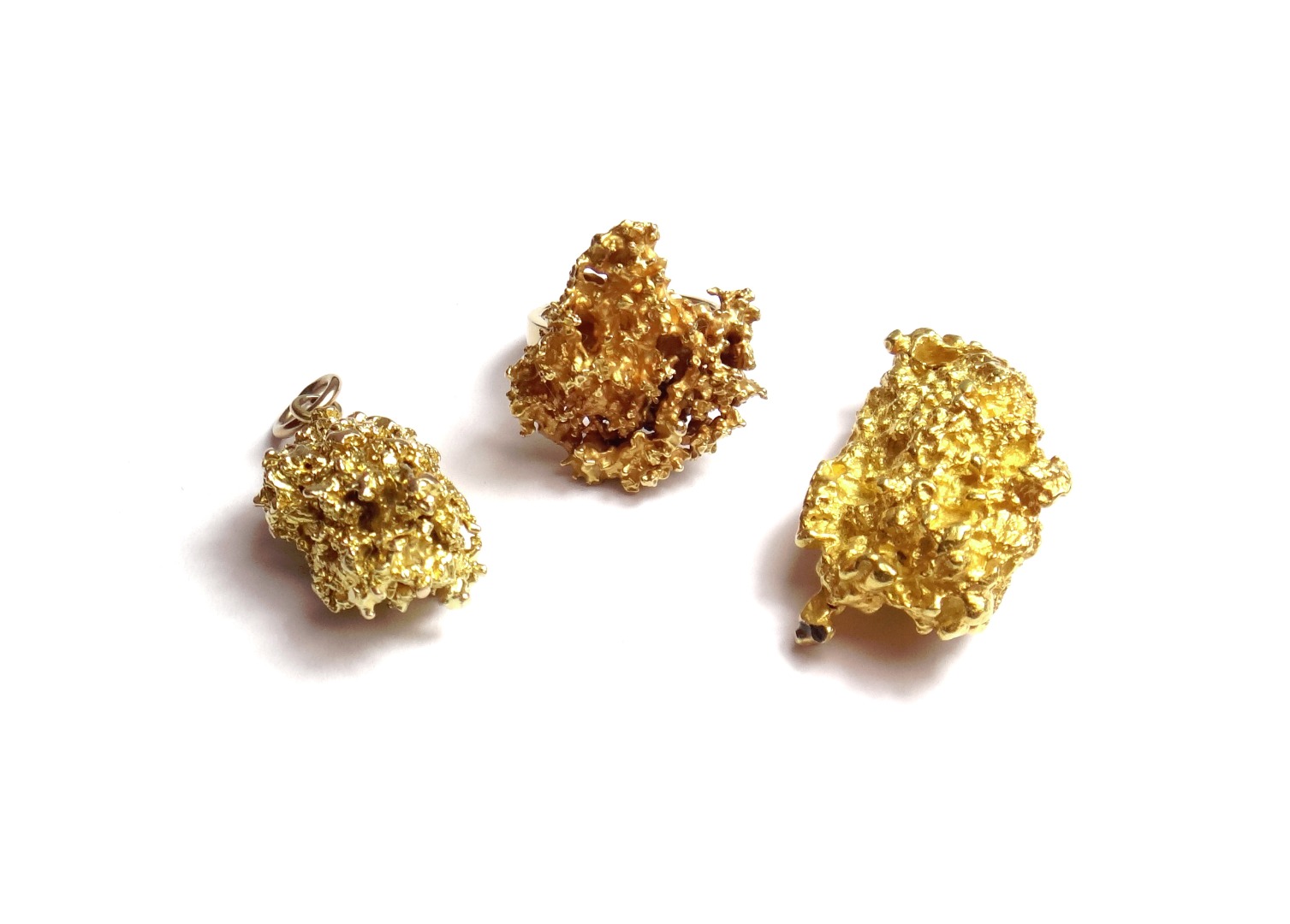 Appraisal: Two gold pendants each formed as a nugget and a