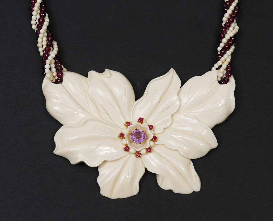 Appraisal: AN EXOTIC CARVED IVORY GEMSTONE NECKLACE Carved ivory flower center