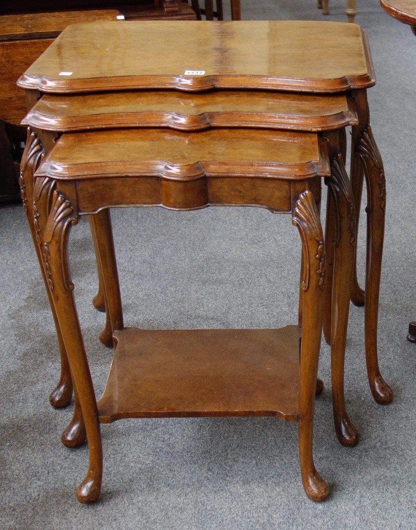 Appraisal: A nest of three th century figured walnut occasional tables