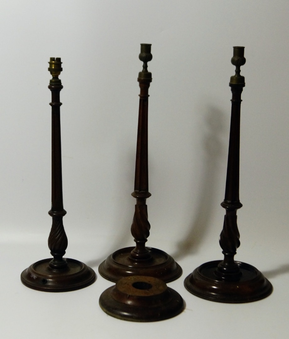 Appraisal: A pair of mahogany candlesticks with slender fluted and tapered