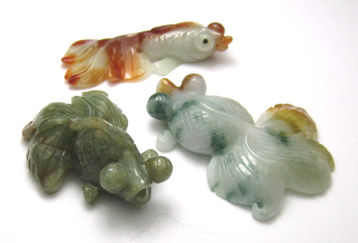 Appraisal: THREE CARVED JADE FIGURAL KOI FISH in various shades of