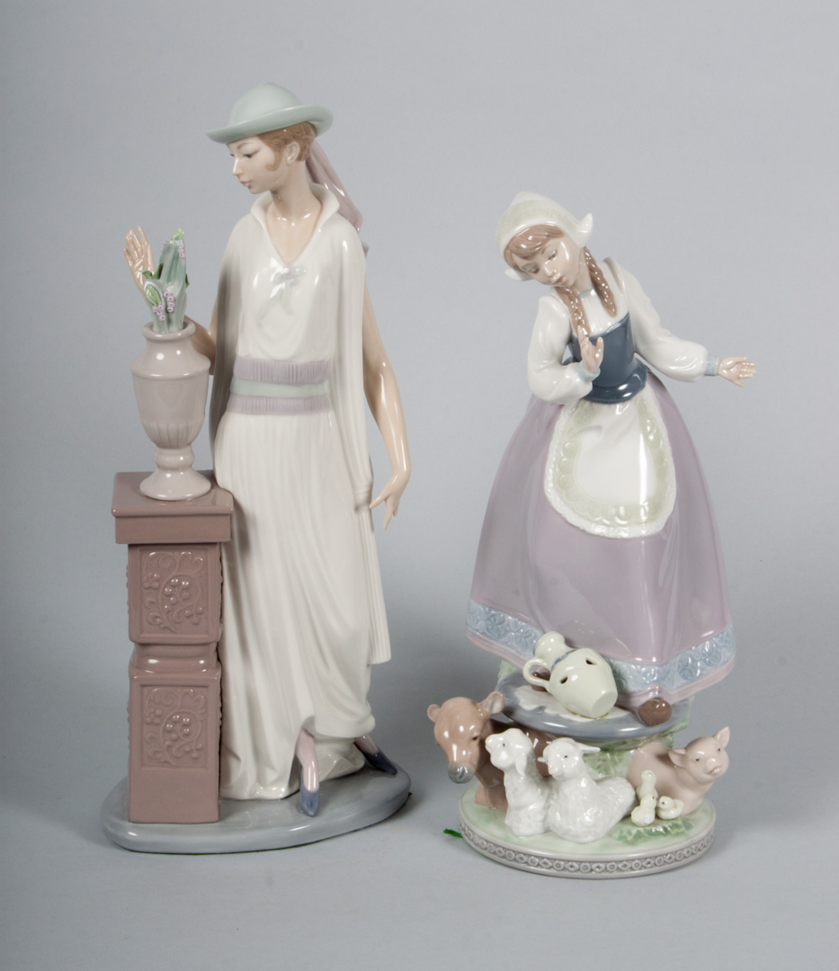 Appraisal: Two Lladro porcelain figural groups Milkmaid in H Woman with