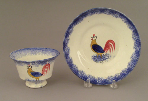 Appraisal: Blue spatter cup and saucer th c with rooster