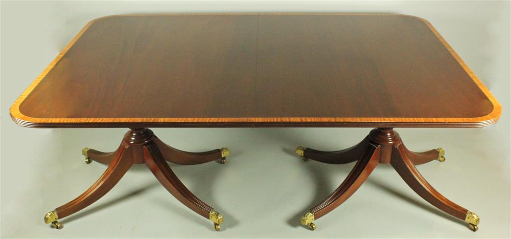 Appraisal: BIGGS SATINWOOD CROSS-BANDED MAHOGANY DOUBLE PEDESTAL DINING TABLE having a