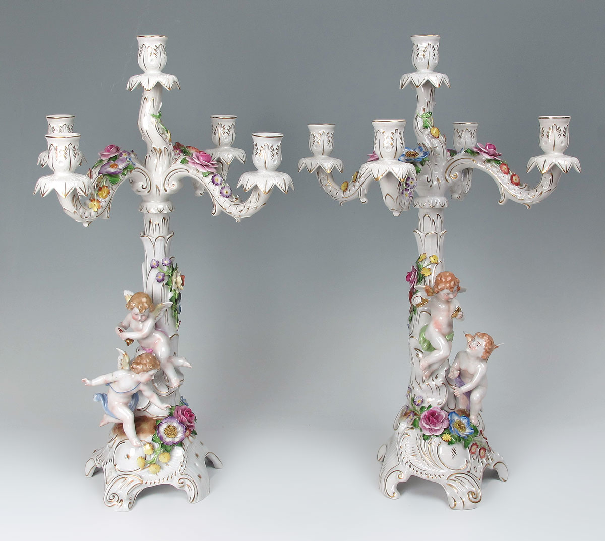 Appraisal: VON SCHIERHOLZ GERMAN PORCELAIN FIGURAL CHERUBIC CANDELABRA Each with playful