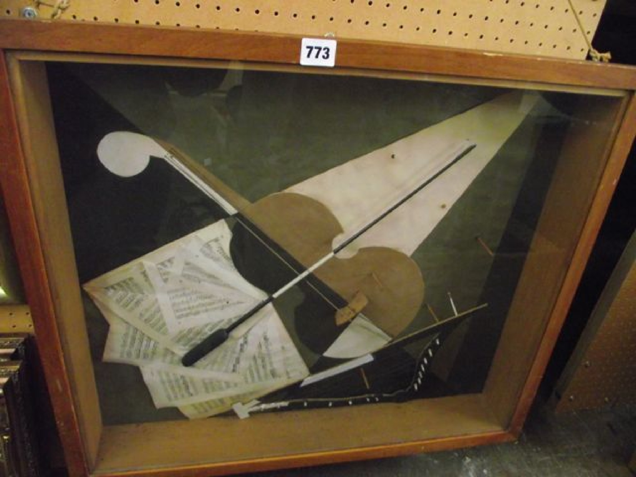 Appraisal: A glazed wooden display case containing a montage of sheets