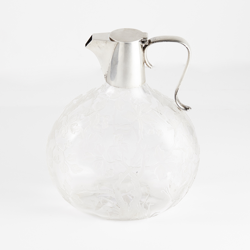 Appraisal: A silver mounted claret jug Hukin and Heath with scroll