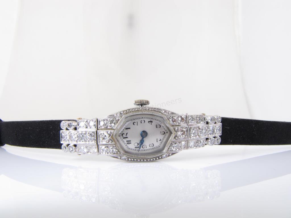 Appraisal: Antique diamond encrusted wristwatch on black suede strap maker unknown