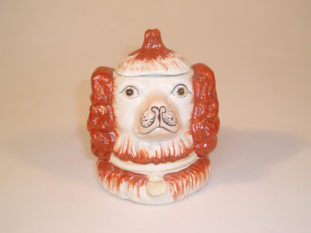 Appraisal: A Staffordshire pottery double side tobacco jar and cover modelled