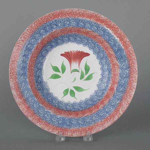 Appraisal: Red and blue spatter shallow bowl with cockscomb decoration th