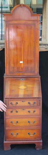 Appraisal: A REPRODUCTION YEW WOOD BUREAU CUPBOARD the upper section enclosed