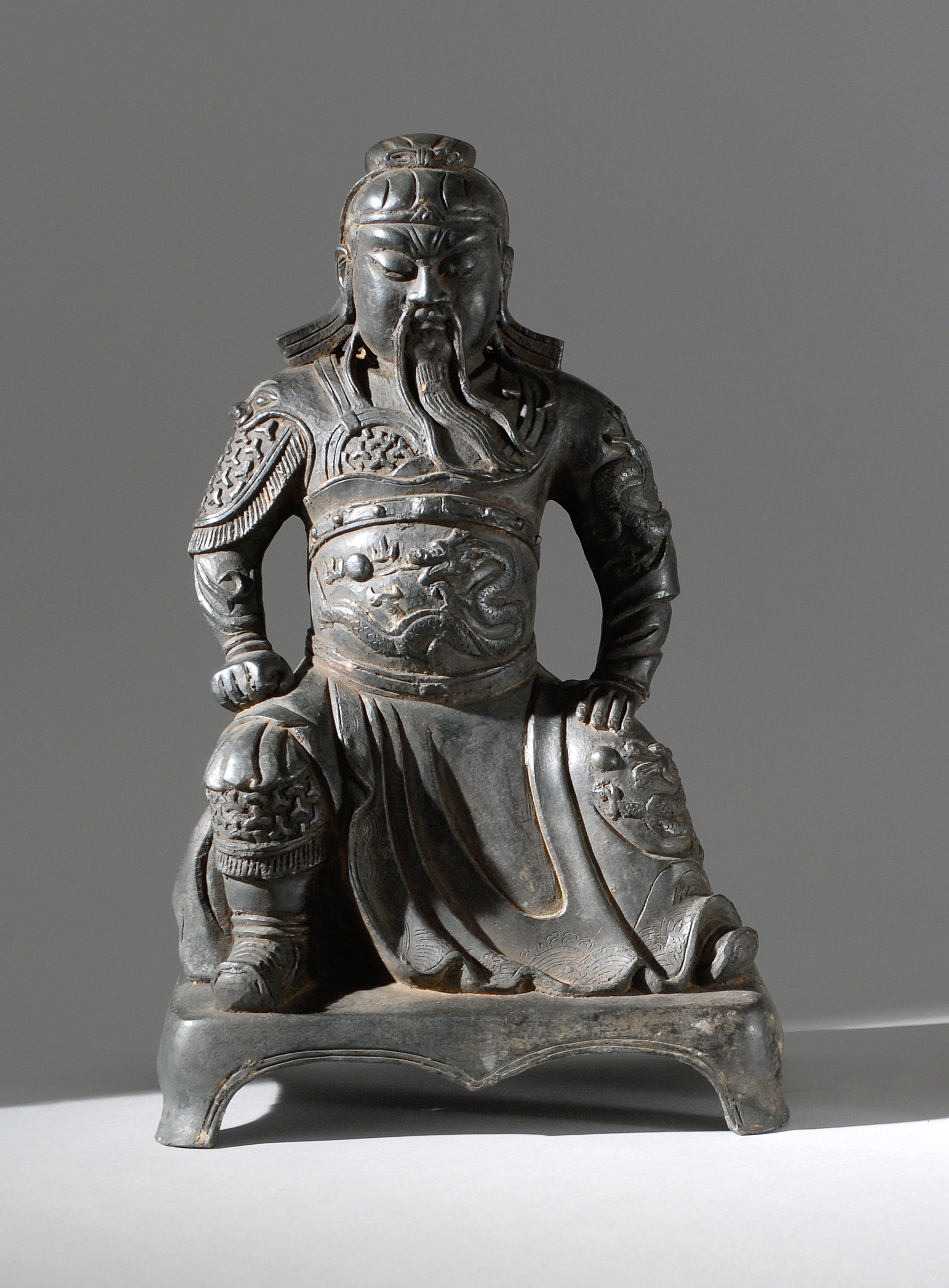 Appraisal: BRONZE FIGURE OF GUANDI Ming StyleSeated on a four-footed base