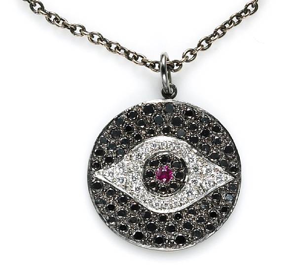 Appraisal: A black diamond diamond and ruby evil eye pendant with