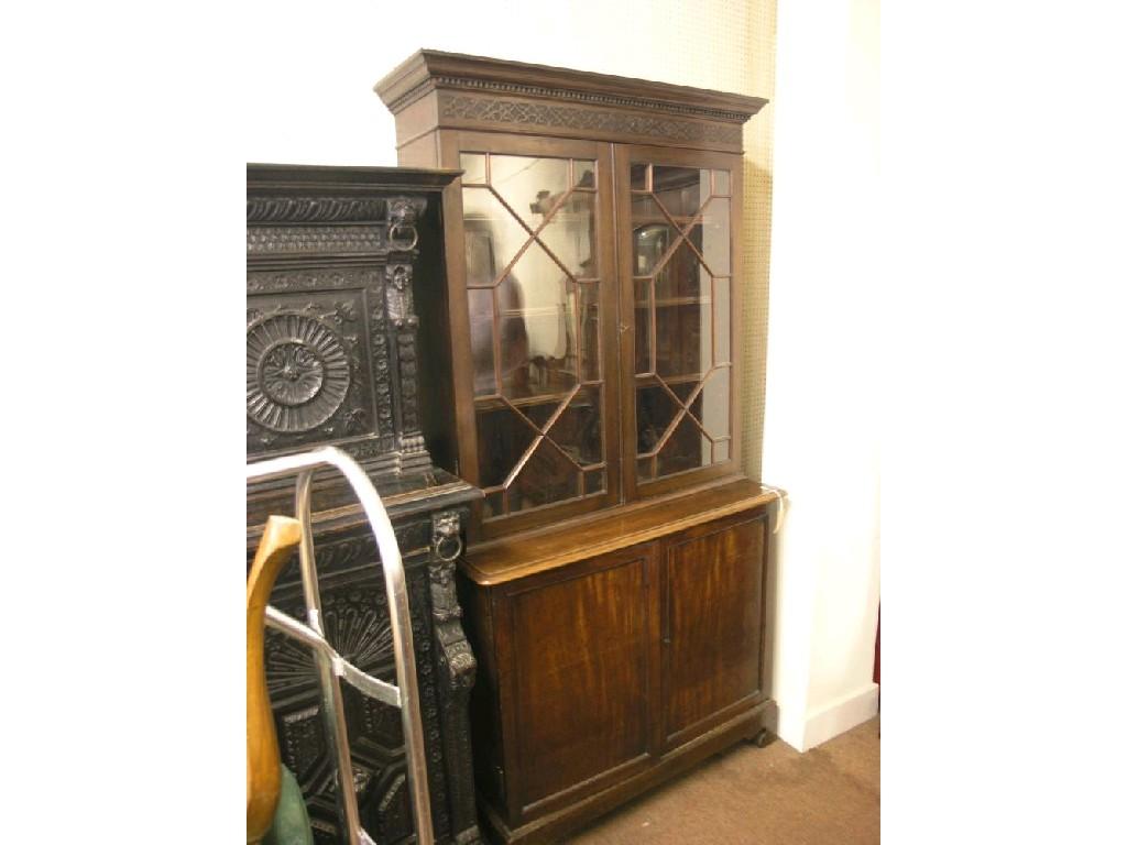 Appraisal: A Victorian mahogany tall bookcase blind-fret frieze above thirteen-pane astragal-glazed