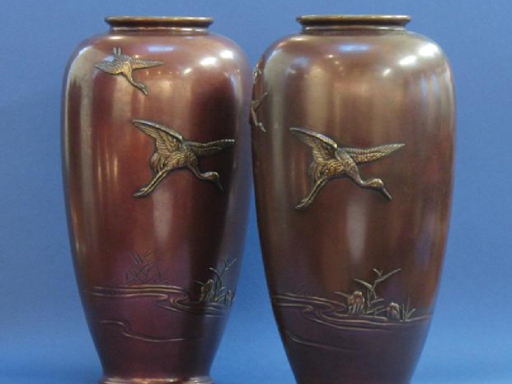 Appraisal: A PAIR OF JAPANESE BRONZE VASES of ovoid form decorated