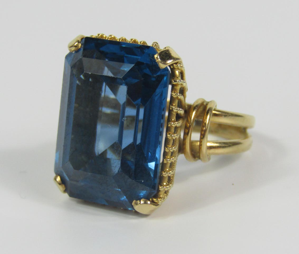 Appraisal: A yellow metal and emerald cut blue topaz dress ring