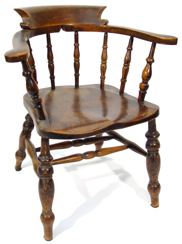 Appraisal: Victorian elm and beech smoker's bow armchair with turned supports