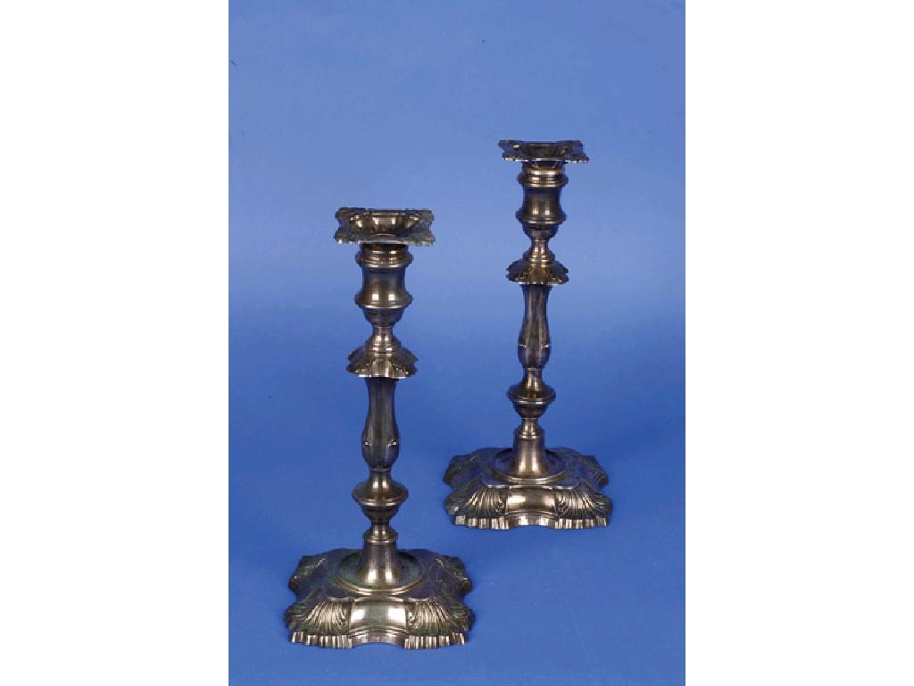 Appraisal: A PAIR OF VICTORIAN CANDLESTICKS with waisted knopped columns with