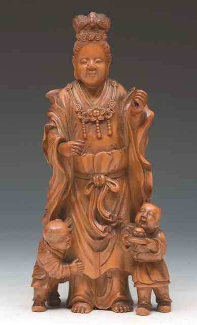 Appraisal: A CHINESE CARVED BOXWOOD MODEL OF GUANYIN signed to the