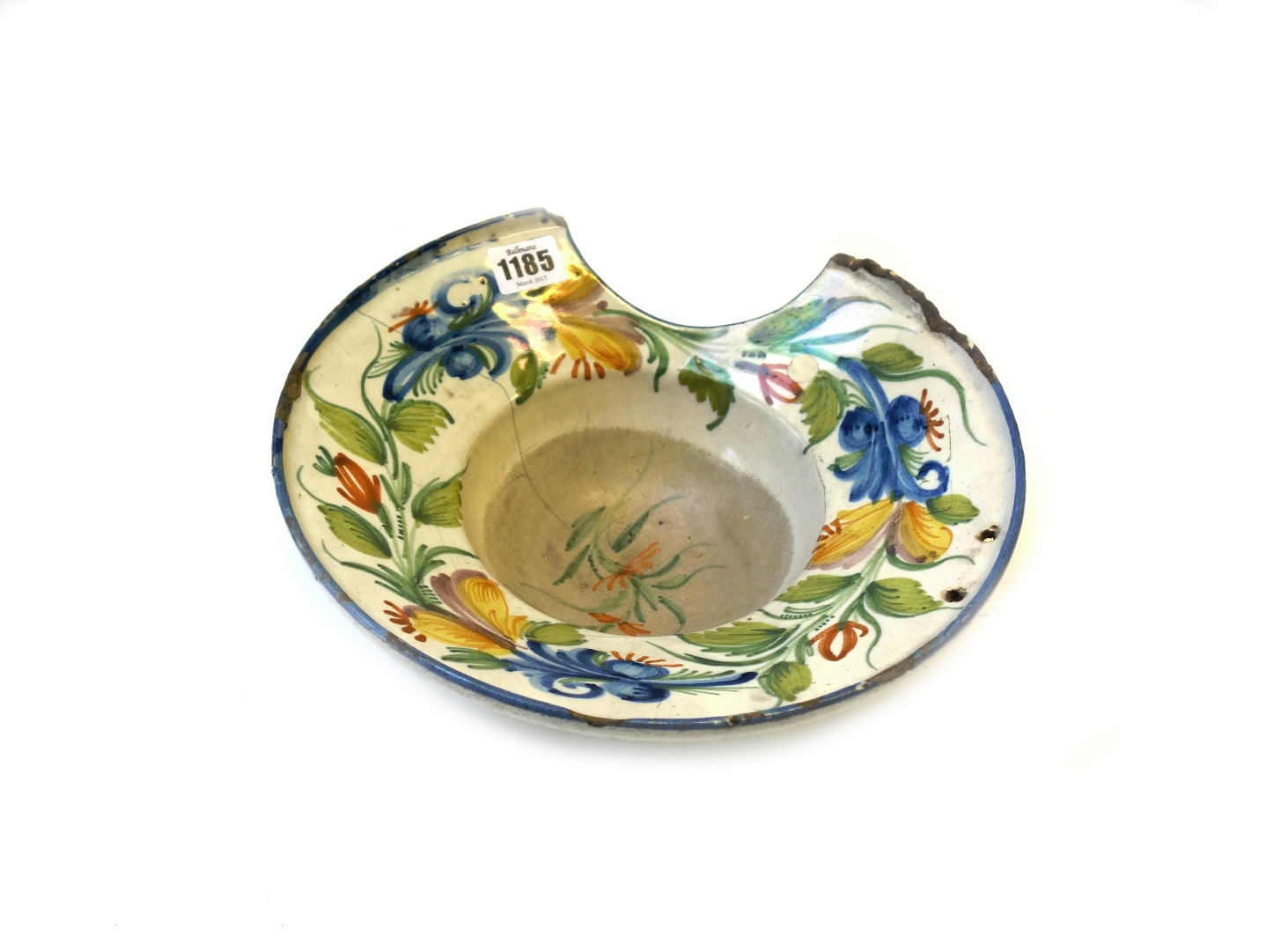 Appraisal: A French faience barber's bowl th century decorated with a