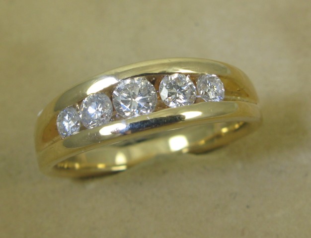 Appraisal: MAN'S DIAMOND AND EIGHTEEN KARAT GOLD RING featuring a channel