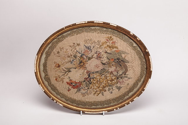 Appraisal: A TH CENTURY PETIT POINT OVAL NEEDLEWORK PANEL of tropical