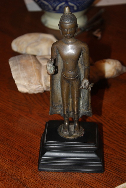 Appraisal: A BRONZE STANDING BUDDHA his right hand in teaching gesture