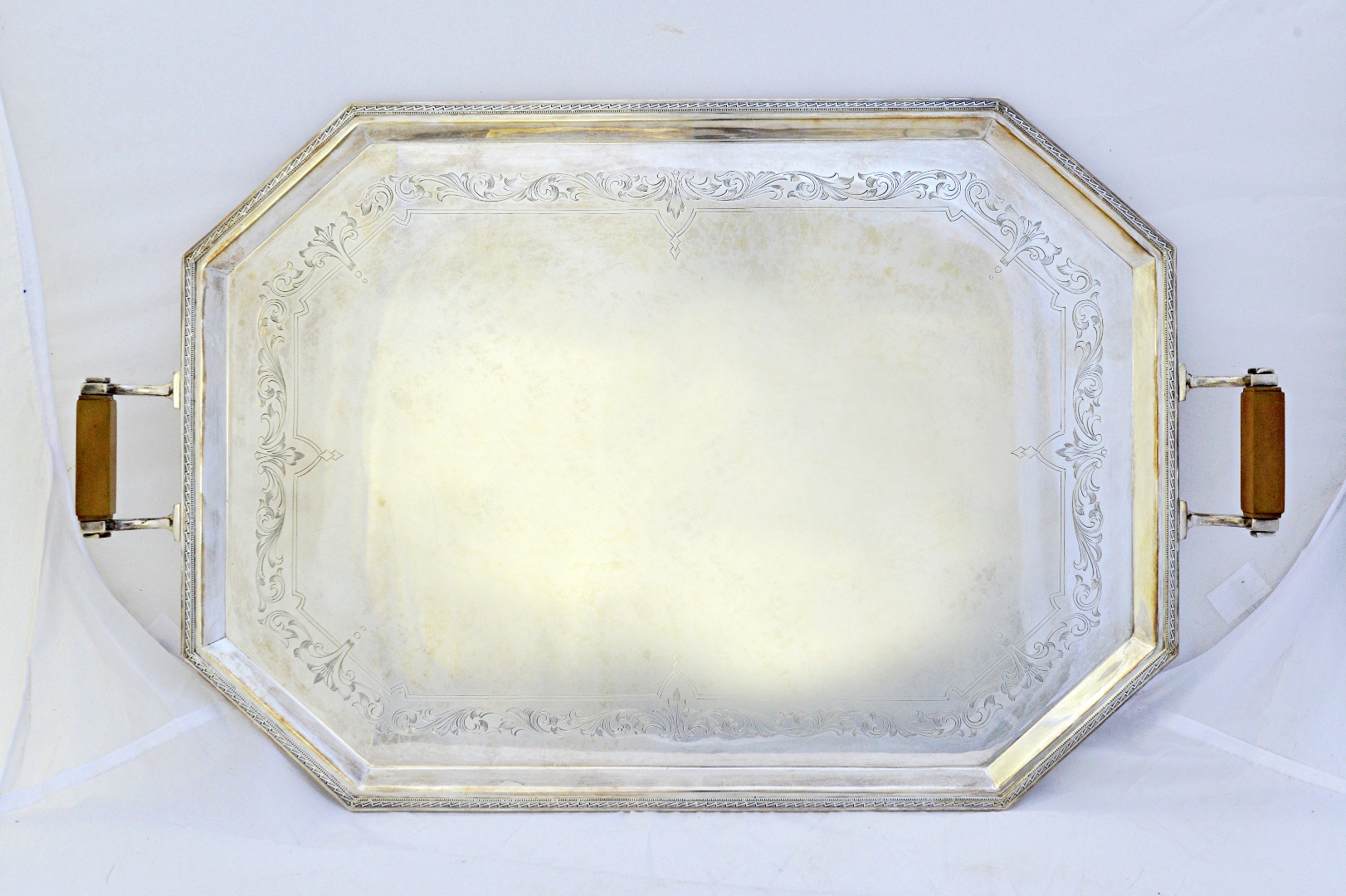 Appraisal: A silver twin handled cut cornered rectangular tray decorated with