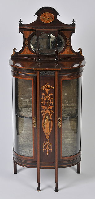 Appraisal: AN EDWARDIAN MAHOGANY AND INLAID BOW FRONTED CABINET the top