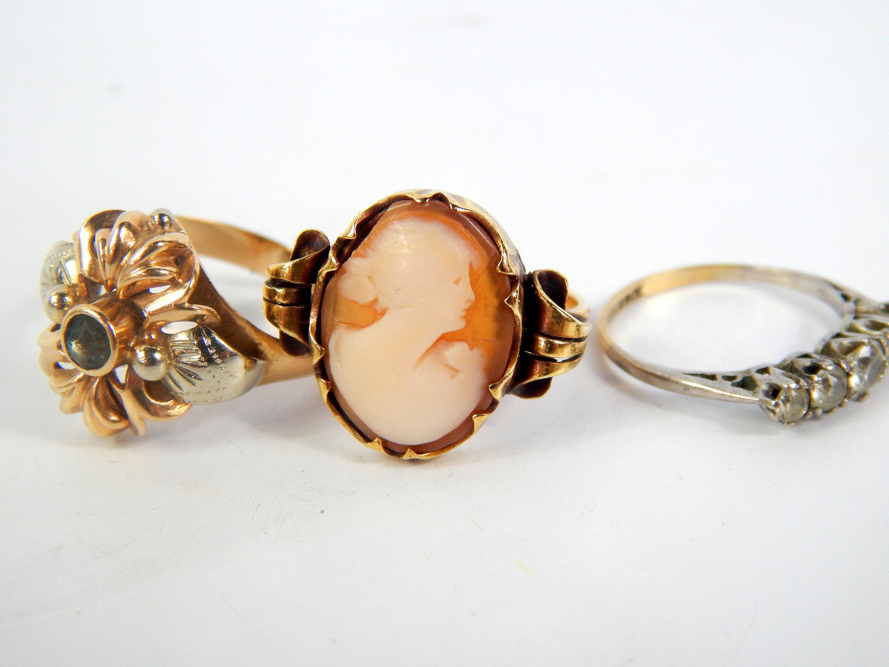 Appraisal: Three gem set rings one set with a cameo bust