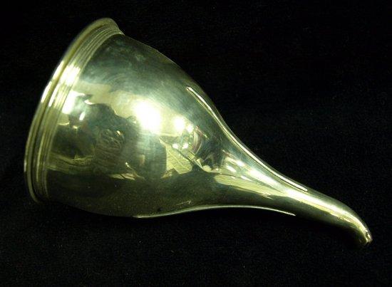 Appraisal: A wine funnel of plain form with reeded rims maker