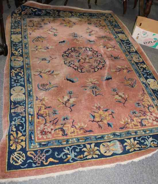 Appraisal: A CHINESE WOOL CARPET on pink ground with stylised decoration