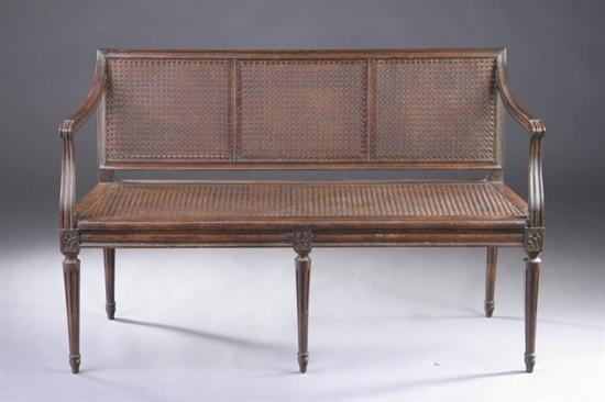 Appraisal: LOUIS XVI STYLE DIMINUTIVE FRUITWOOD CANAPE th century With caned