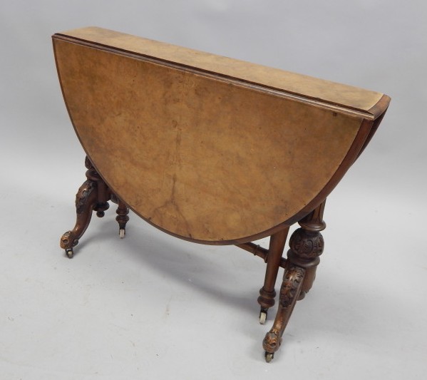 Appraisal: A Victorian burr walnut Sutherland table the oval quarter veneered