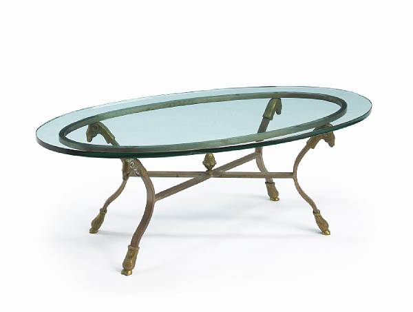 Appraisal: A wrought and gilt metal oval coffee table the the