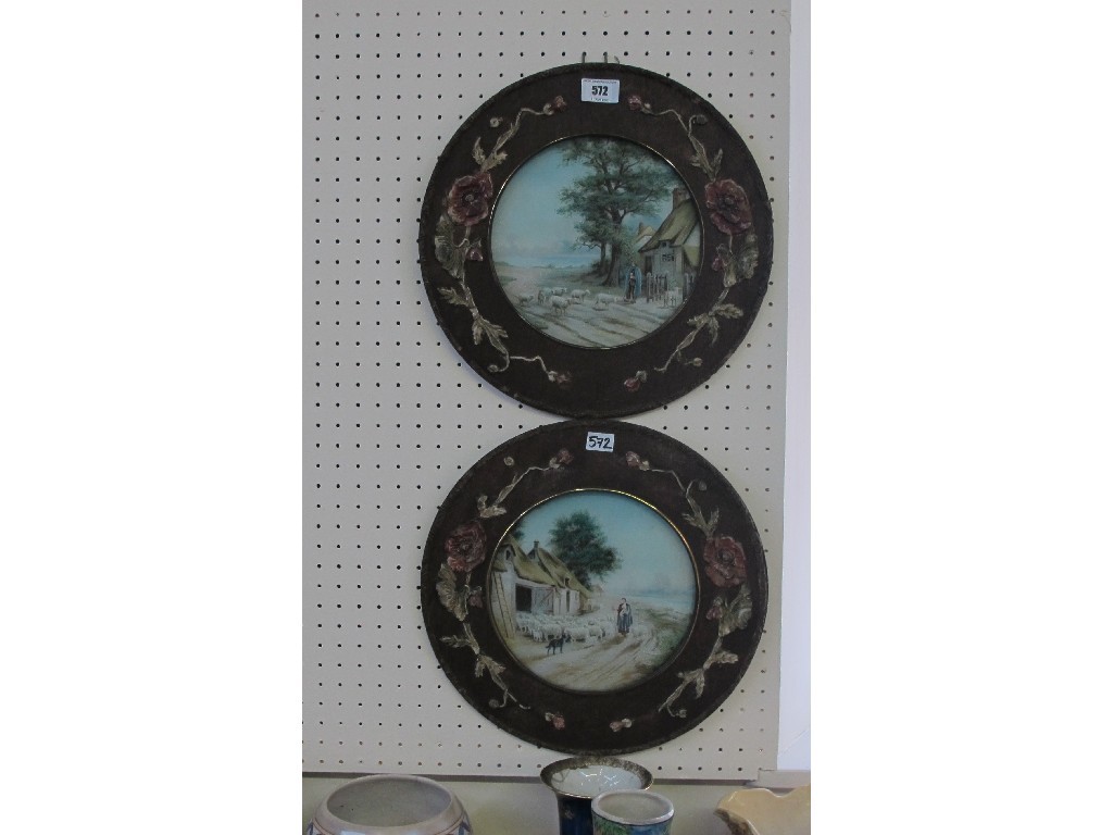 Appraisal: Two circular rural scene prints in Art Nouveau style frames