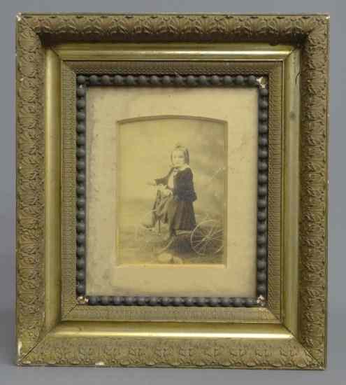 Appraisal: th c photograph little girl astride a tricycle Image ''