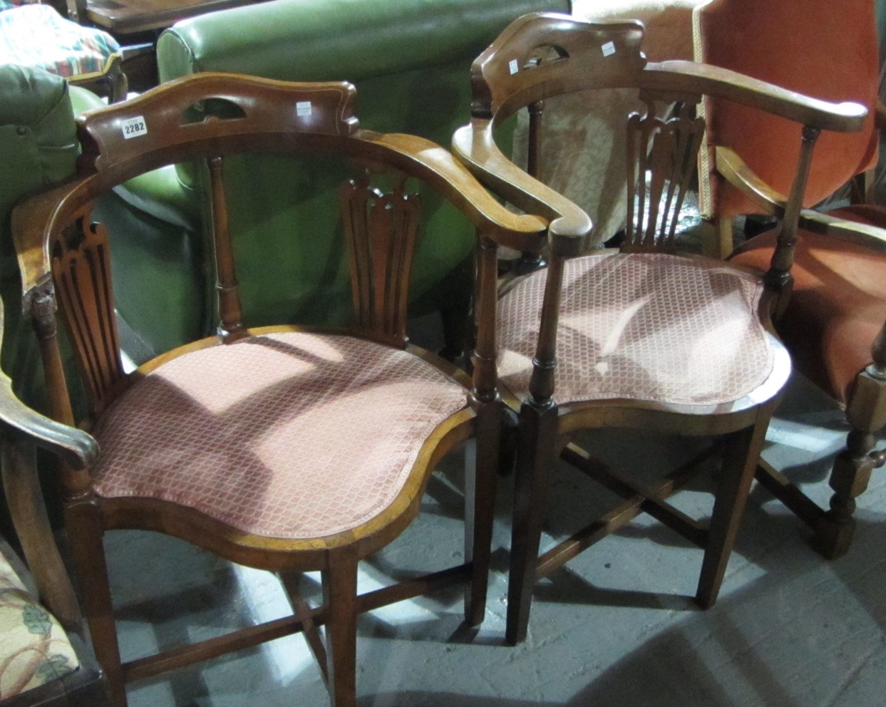 Appraisal: A pair of Edwardian inlaid mahogany corner chairs on tapering