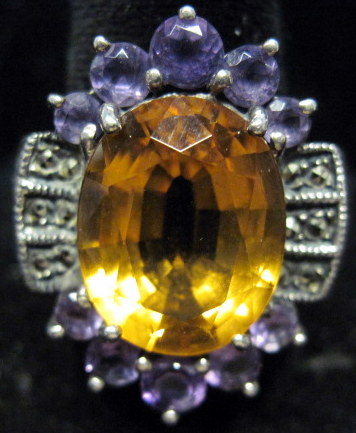 Appraisal: Sterling silver citrine and amethyst ring Oval citrine accented by