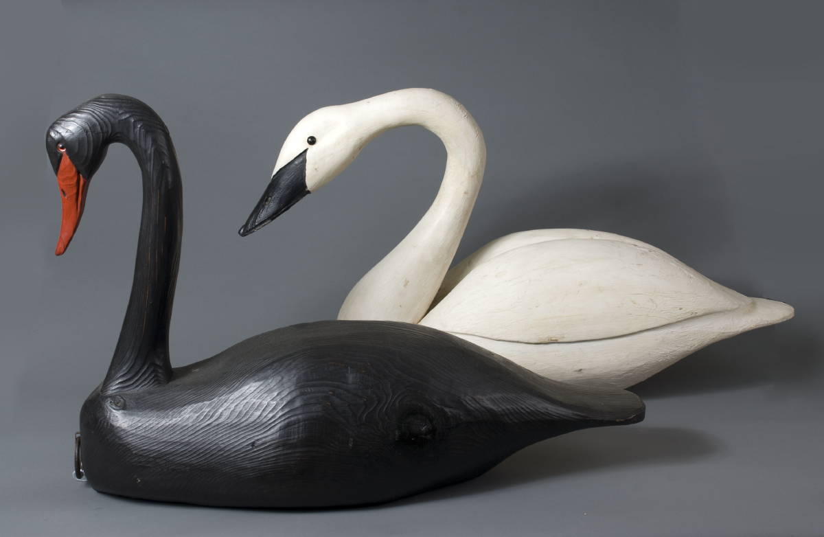 Appraisal: TWO CARVED AND PAINTED SWAN DECOYS The black swan branded