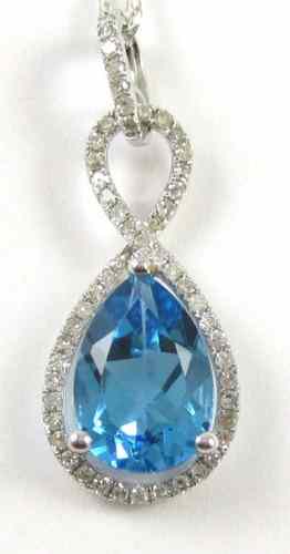 Appraisal: BLUE TOPAZ AND DIAMOND PENDANT NECKLACE suspended on an inch