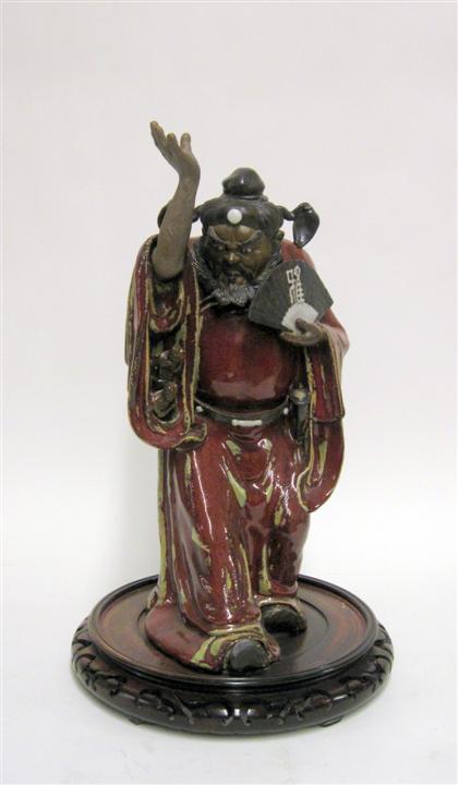 Appraisal: Chinese flambe glazed pottery immortal figureTall standing figure with fan