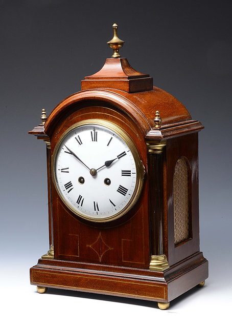 Appraisal: A FRENCH MAHOGANY MANTEL CLOCK with convex white enamel Roman