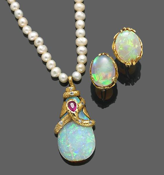 Appraisal: An opal cultured pearl diamond and red stone serpent pendant