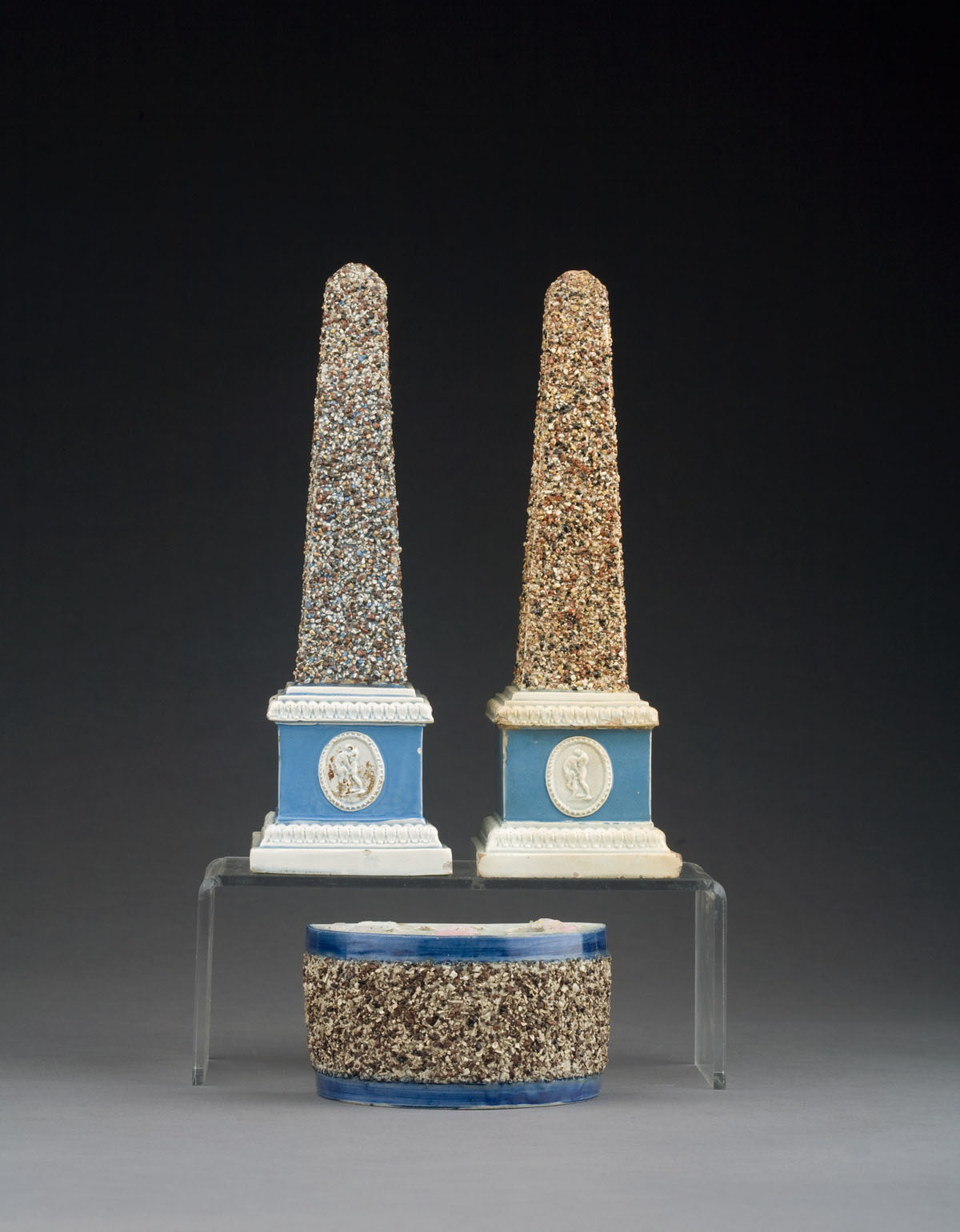 Appraisal: TWO NEARLY INDENTICAL ENGLISH PEARLWARE OBELISKS AND A BOUGH BOT