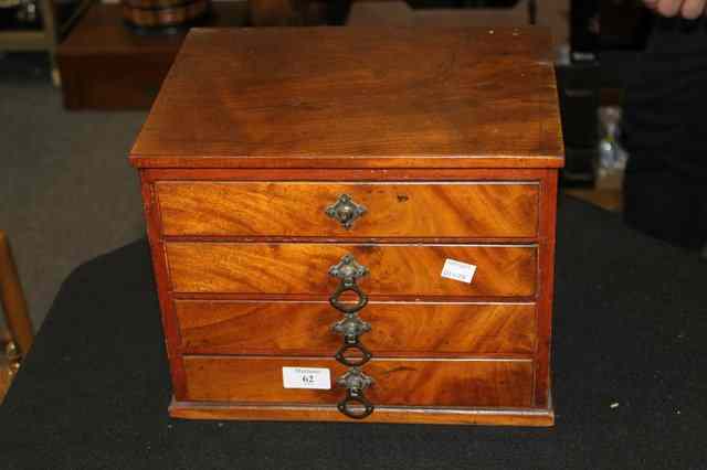 Appraisal: A SMALL VICTORIAN WALNUT CHEST of four drawers with stylised