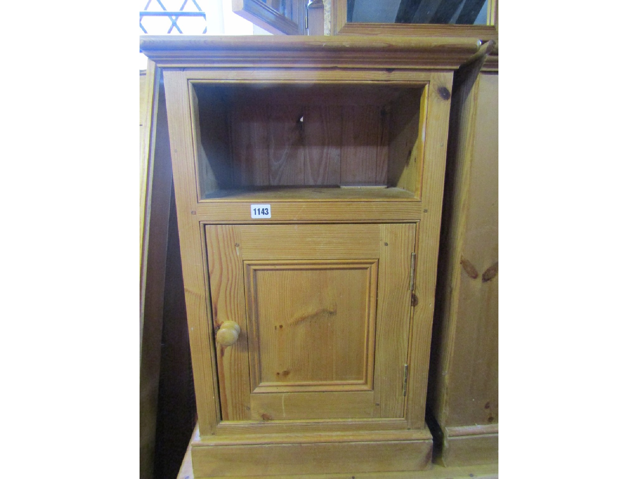 Appraisal: A pair of pine bedside cupboards each enclosed by a