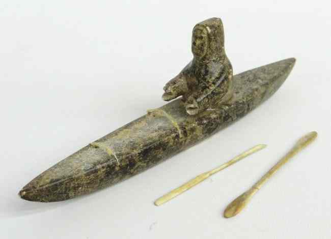 Appraisal: Inuit Eskimo stone sculpture man in kayak with bone paddle