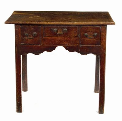 Appraisal: A George III oak lowboy the moulded edge boarded top